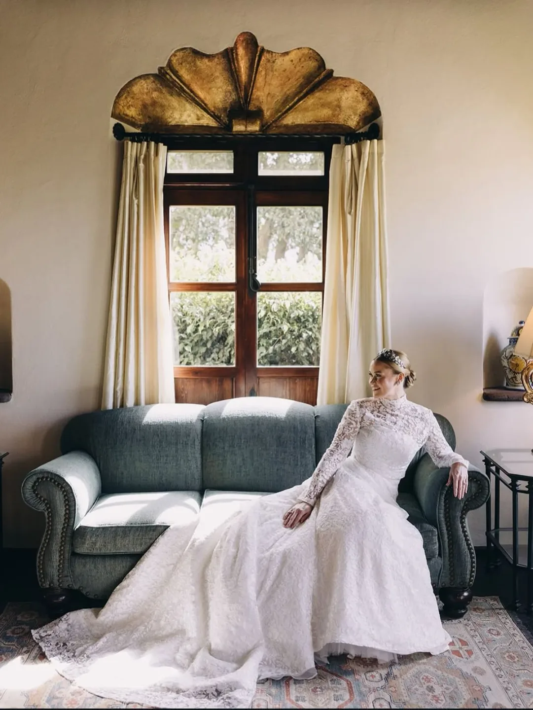 Novia en una habitación luminosa con peinado y maquillaje de boda impecables