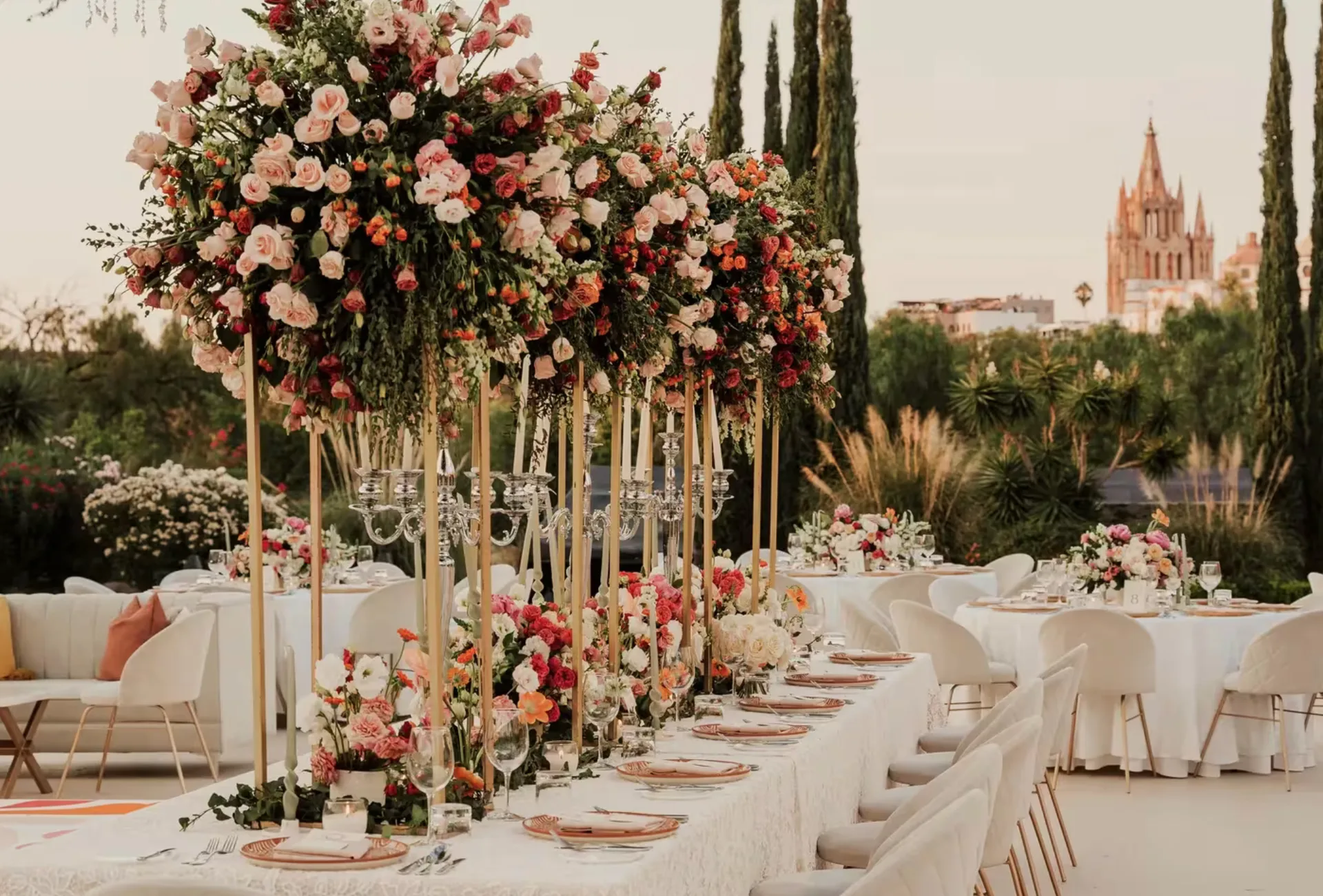 Recepción de boda con flores en el jardín y La Parroquia al fondo en Rosewood